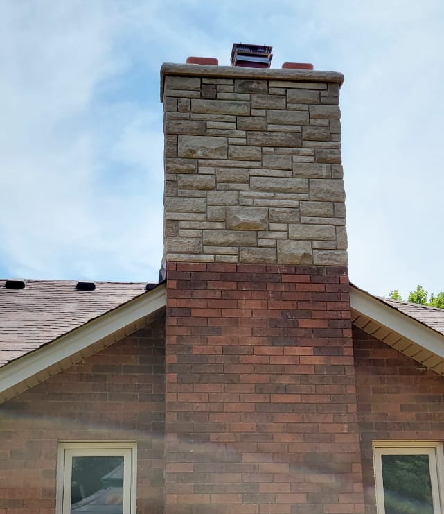 medium size brick and stone chimney of single family home